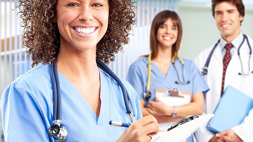 Three doctors smiling.